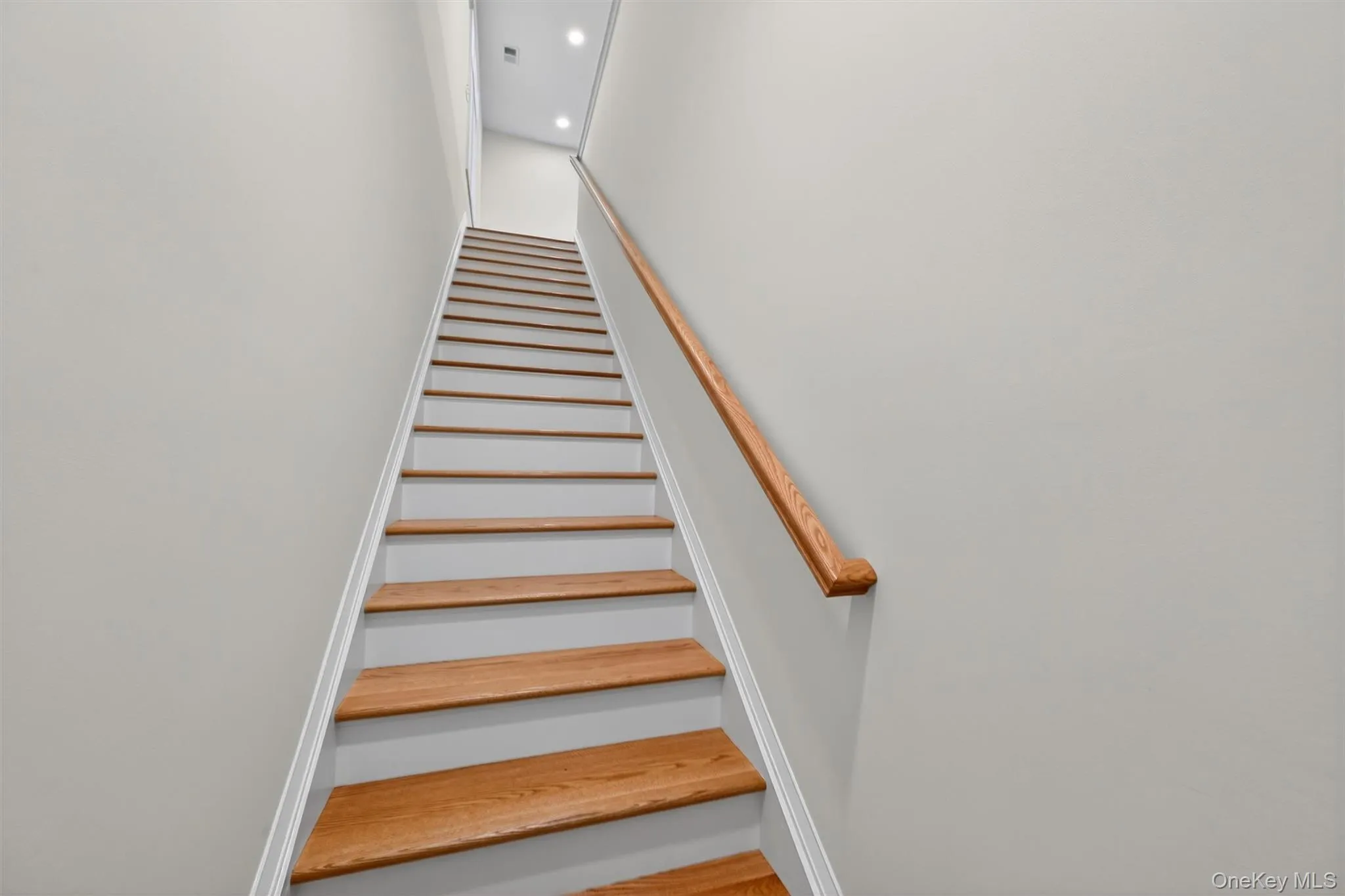 Staircase featuring recessed lighting Staircase featuring recessed lighting