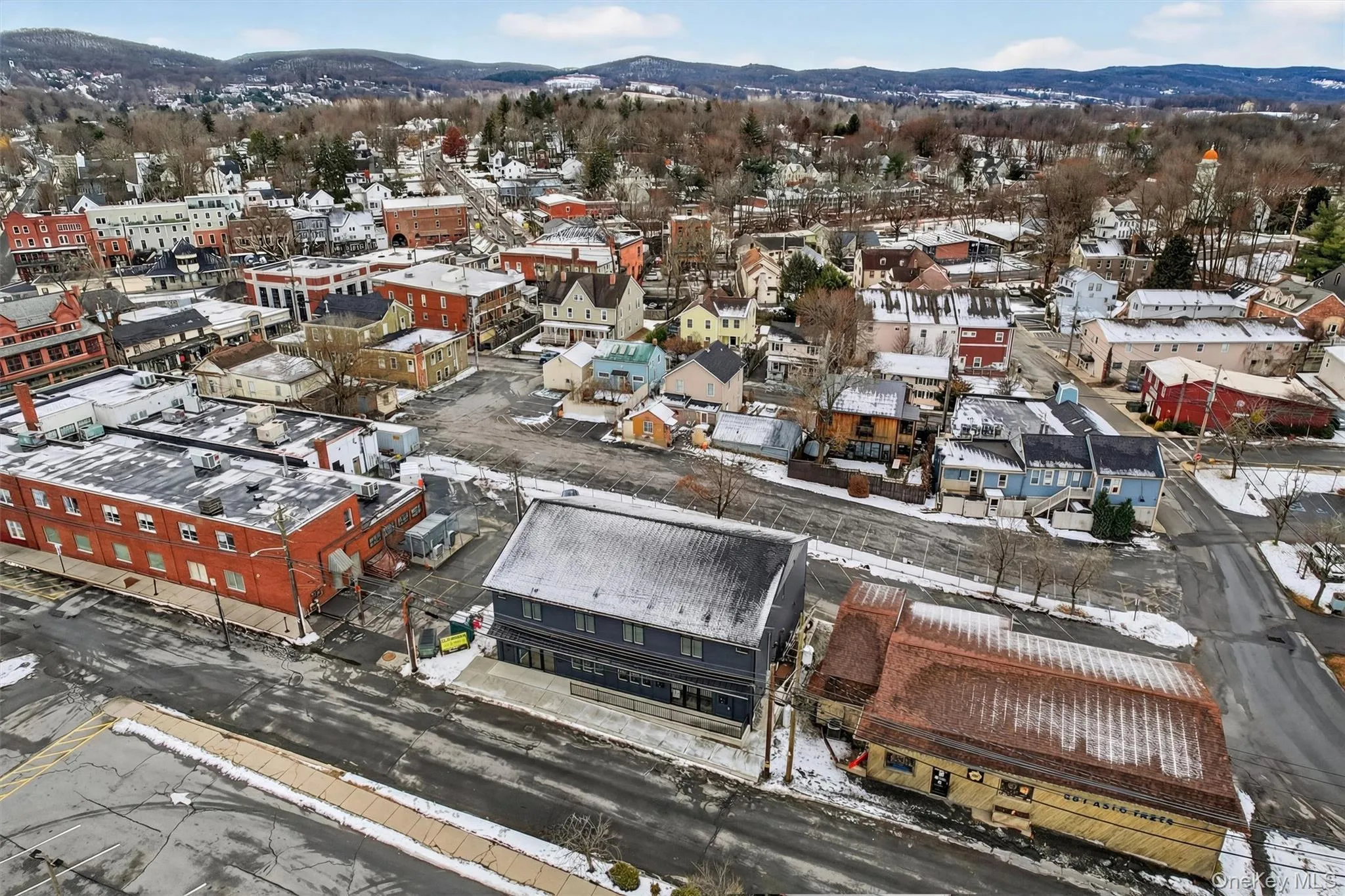 Snowy aerial view featuring a mountain view Snowy aerial view featuring a mountain view