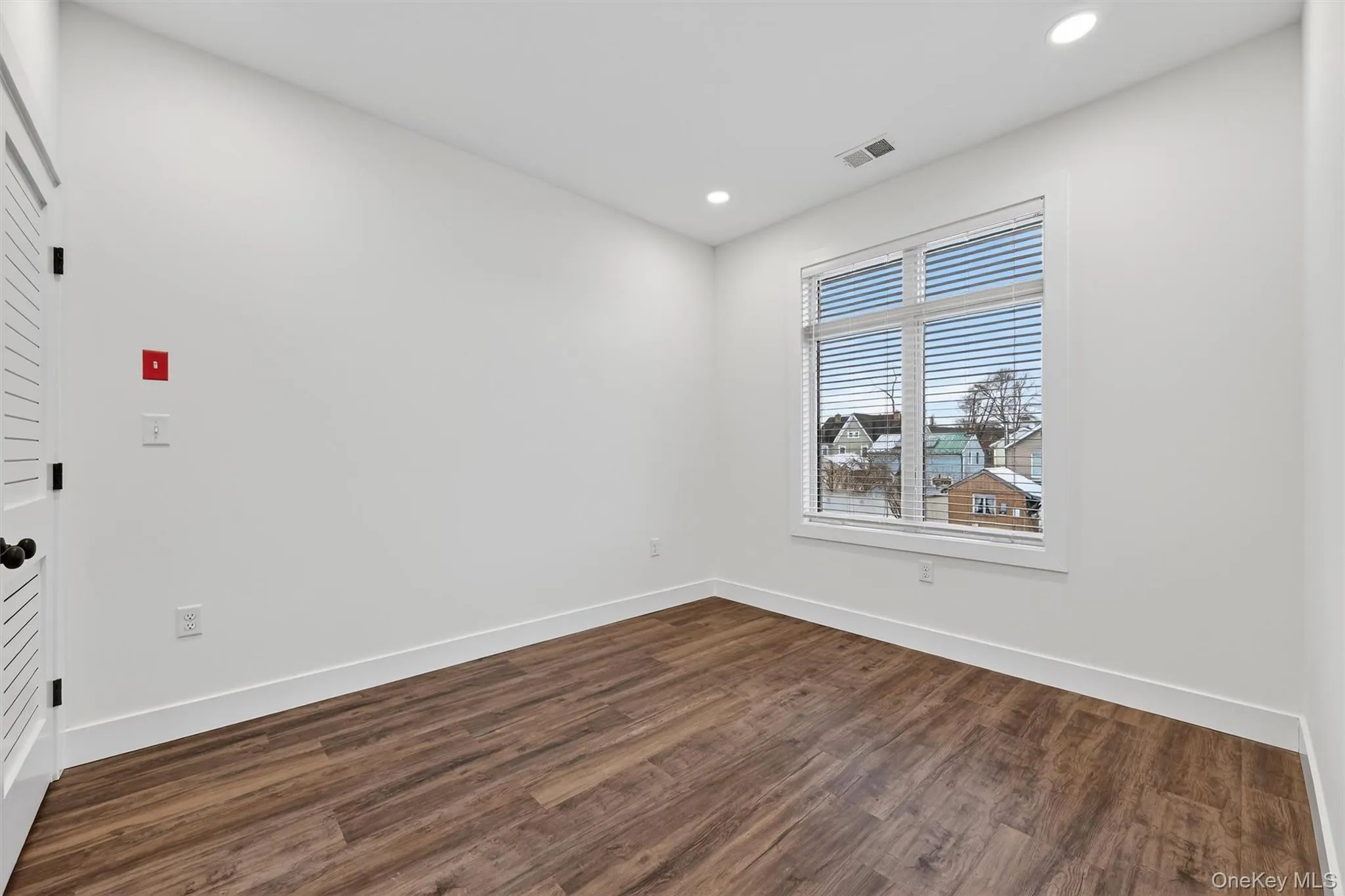 Unfurnished room featuring dark wood finished floors and recessed lighting Unfurnished room featuring dark wood finished floors and recessed lighting