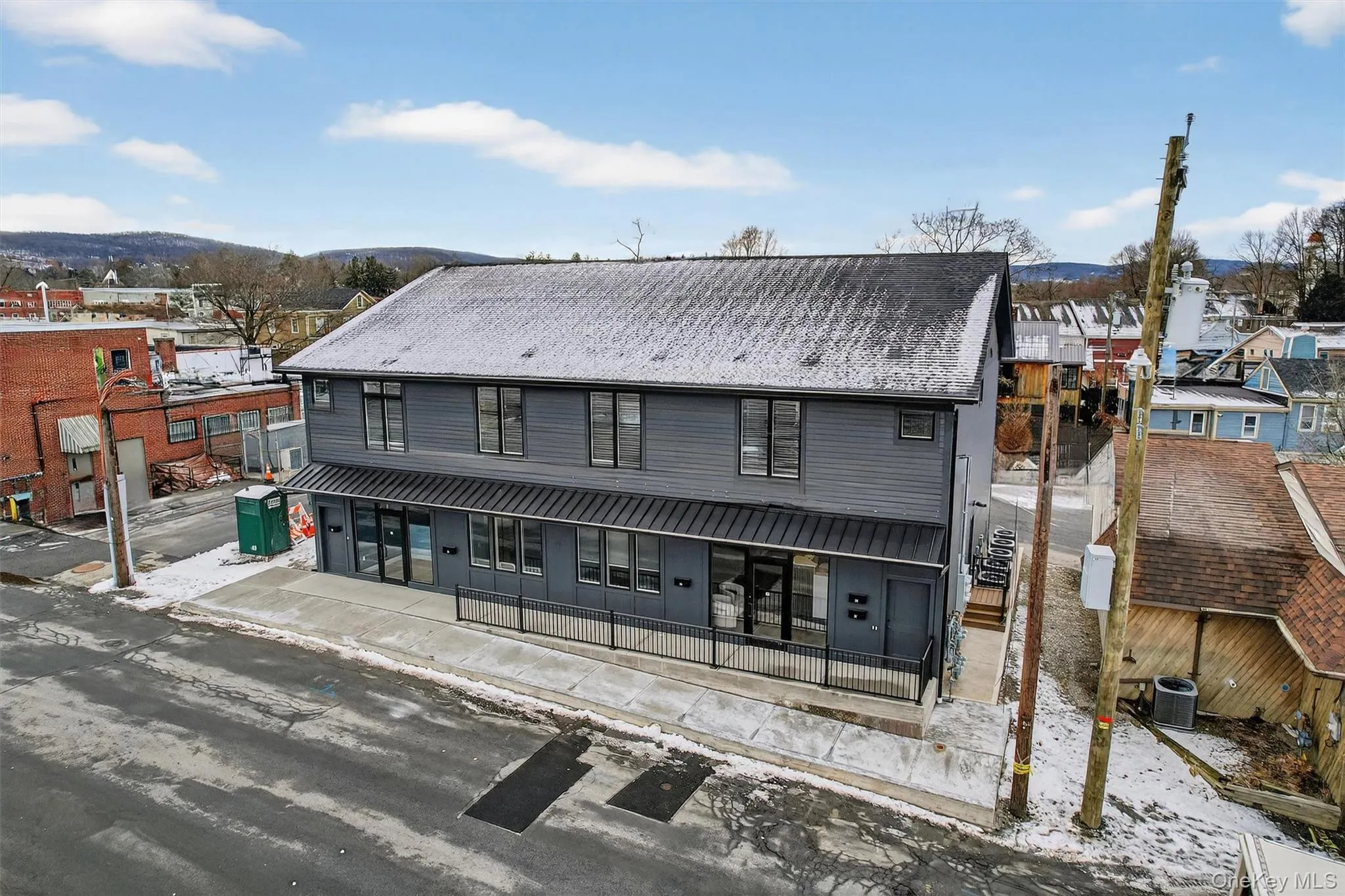 Snow covered rear of property featuring covered porch Snow covered rear of property featuring covered porch