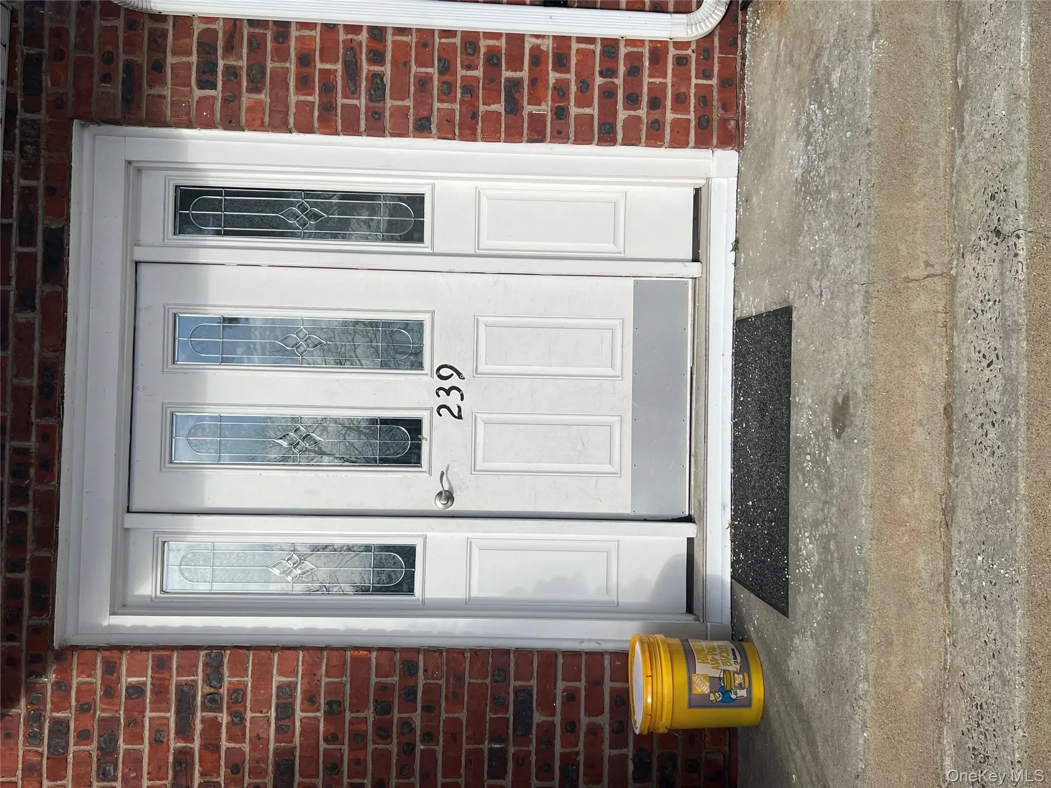 Doorway to property with brick siding and a porch Doorway to property with brick siding and a porch