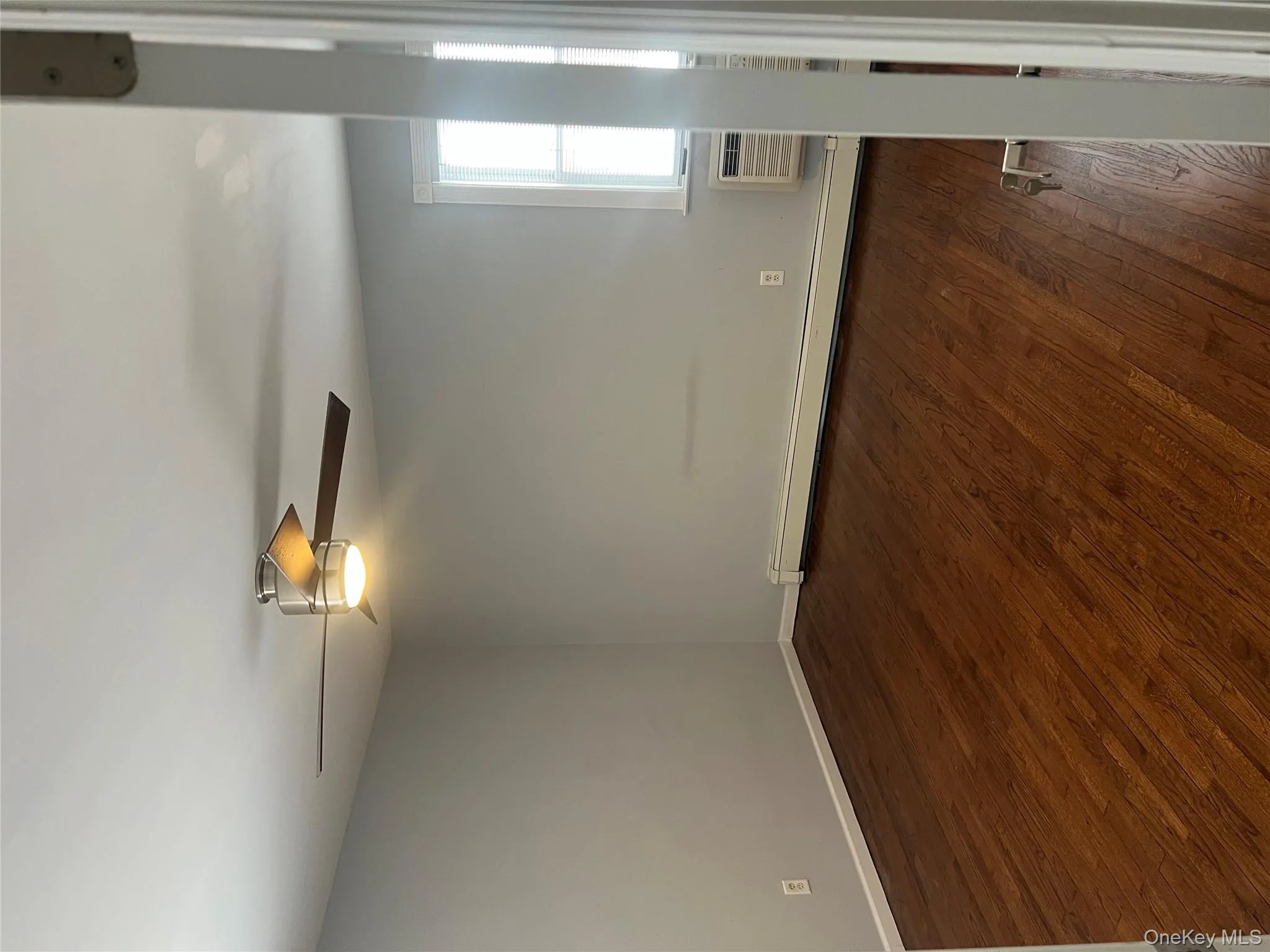 Spare room with dark wood-style flooring, baseboard heating, and a ceiling fan Spare room with dark wood-style flooring, baseboard heating, and a ceiling fan