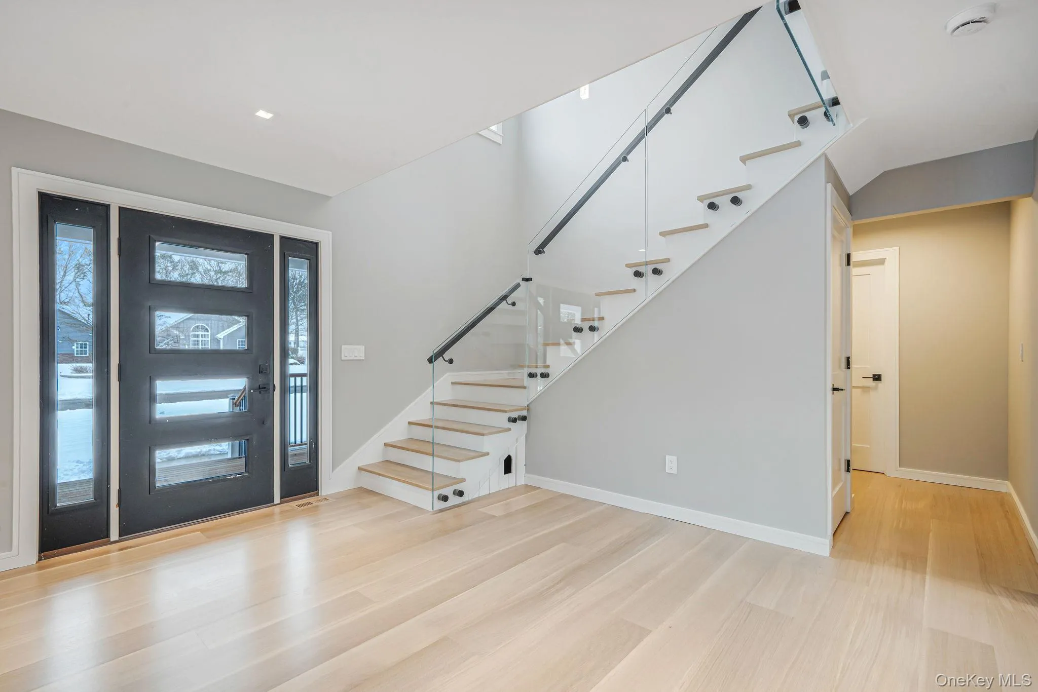 Entryway with stairway and light wood finished floors Entryway with stairway and light wood finished floors