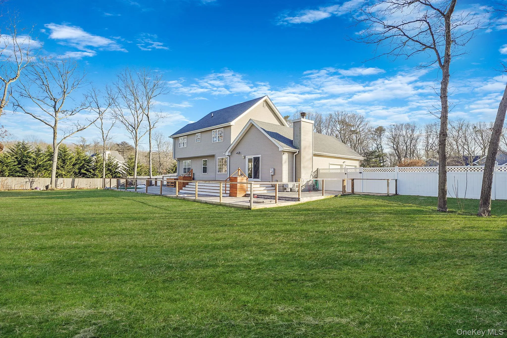 Back of property with a patio area, a fenced backyard, and a chimney Back of property with a patio area, a fenced backyard, and a chimney