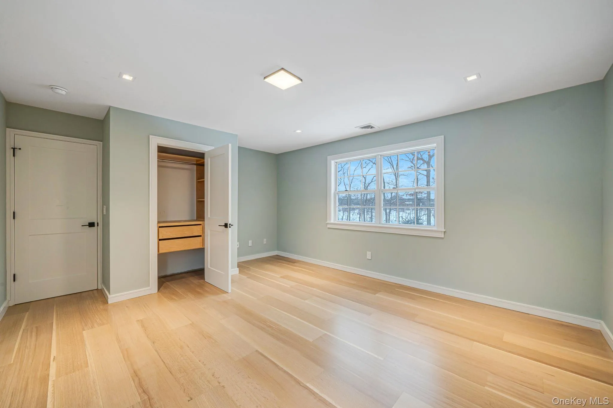 Unfurnished bedroom featuring light wood-type flooring, a closet, and recessed lighting Unfurnished bedroom featuring light wood-type flooring, a closet, and recessed lighting