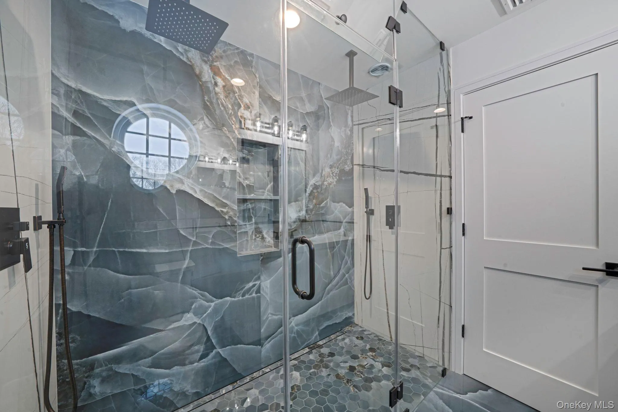 Bathroom featuring a marble finish shower Bathroom featuring a marble finish shower
