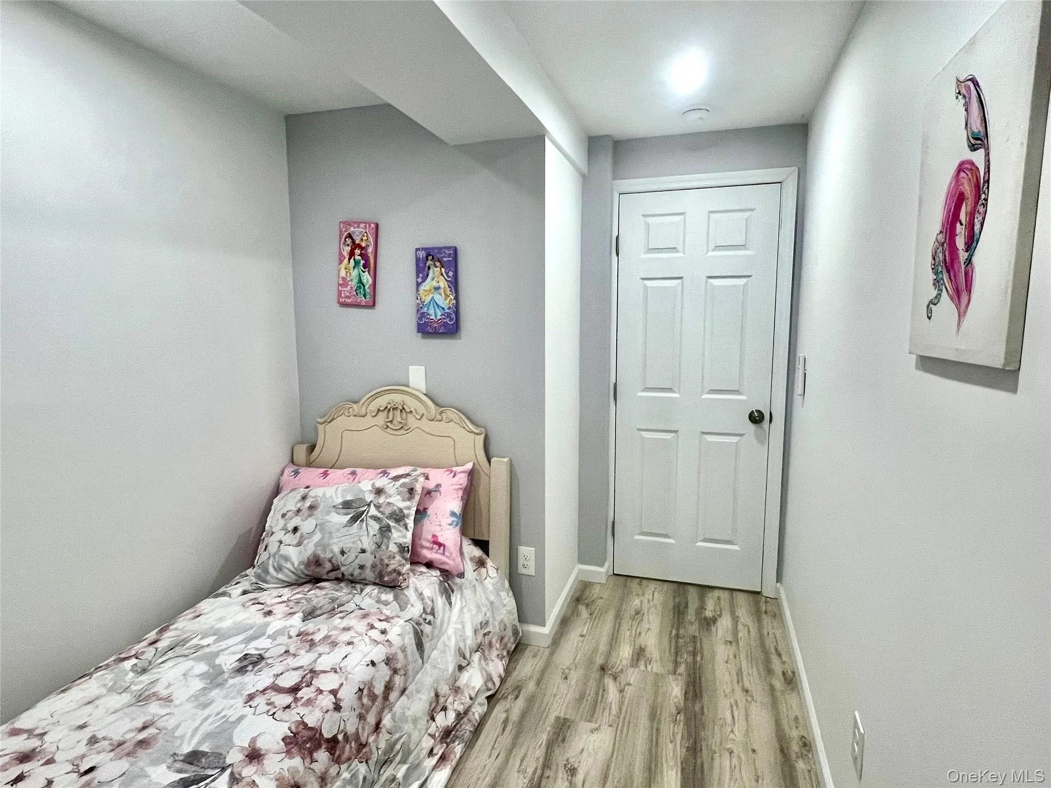 Bedroom featuring baseboards and light wood-style floors Bedroom featuring baseboards and light wood-style floors