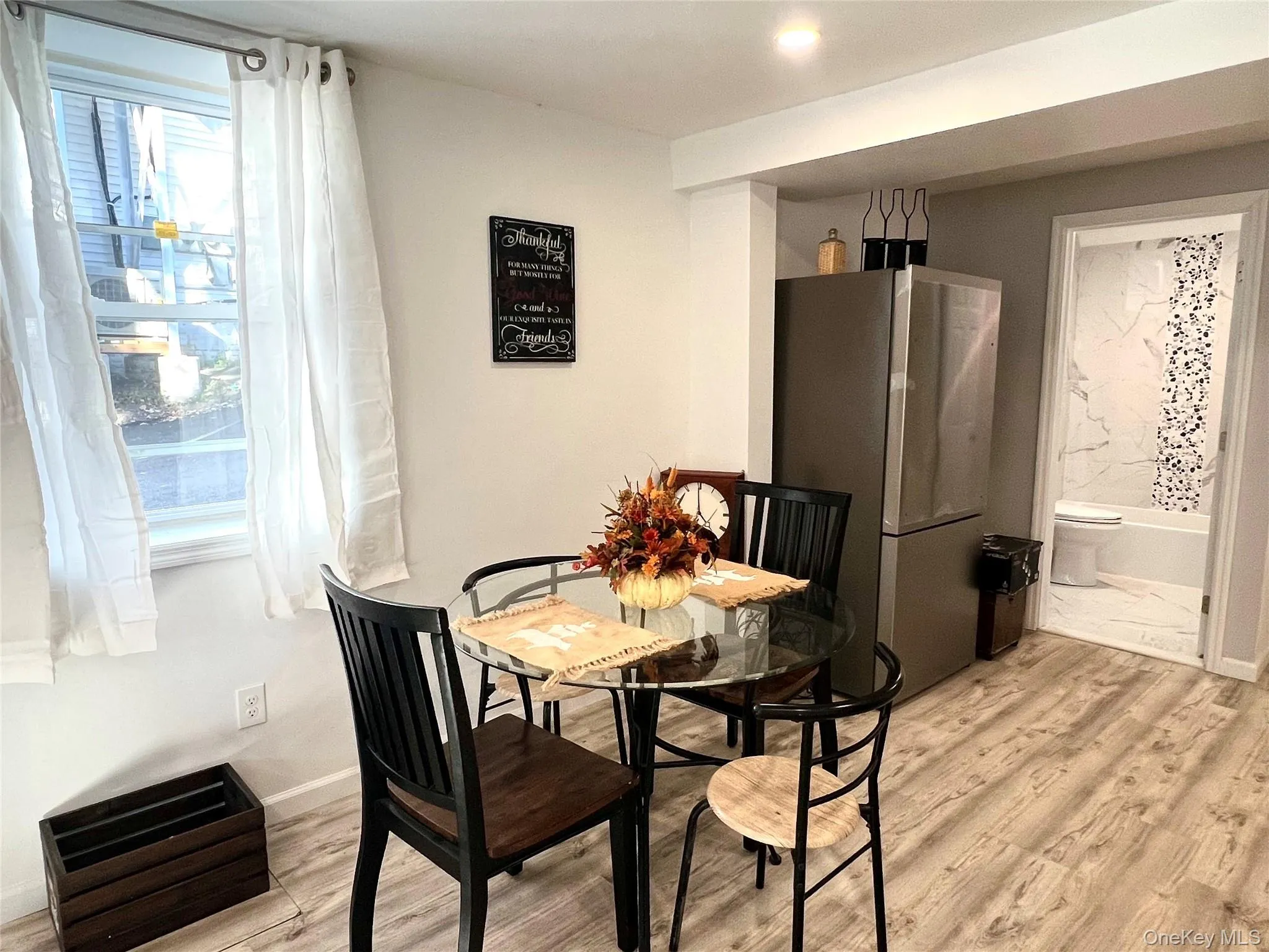 Dining area with light wood-type flooring Dining area with light wood-type flooring