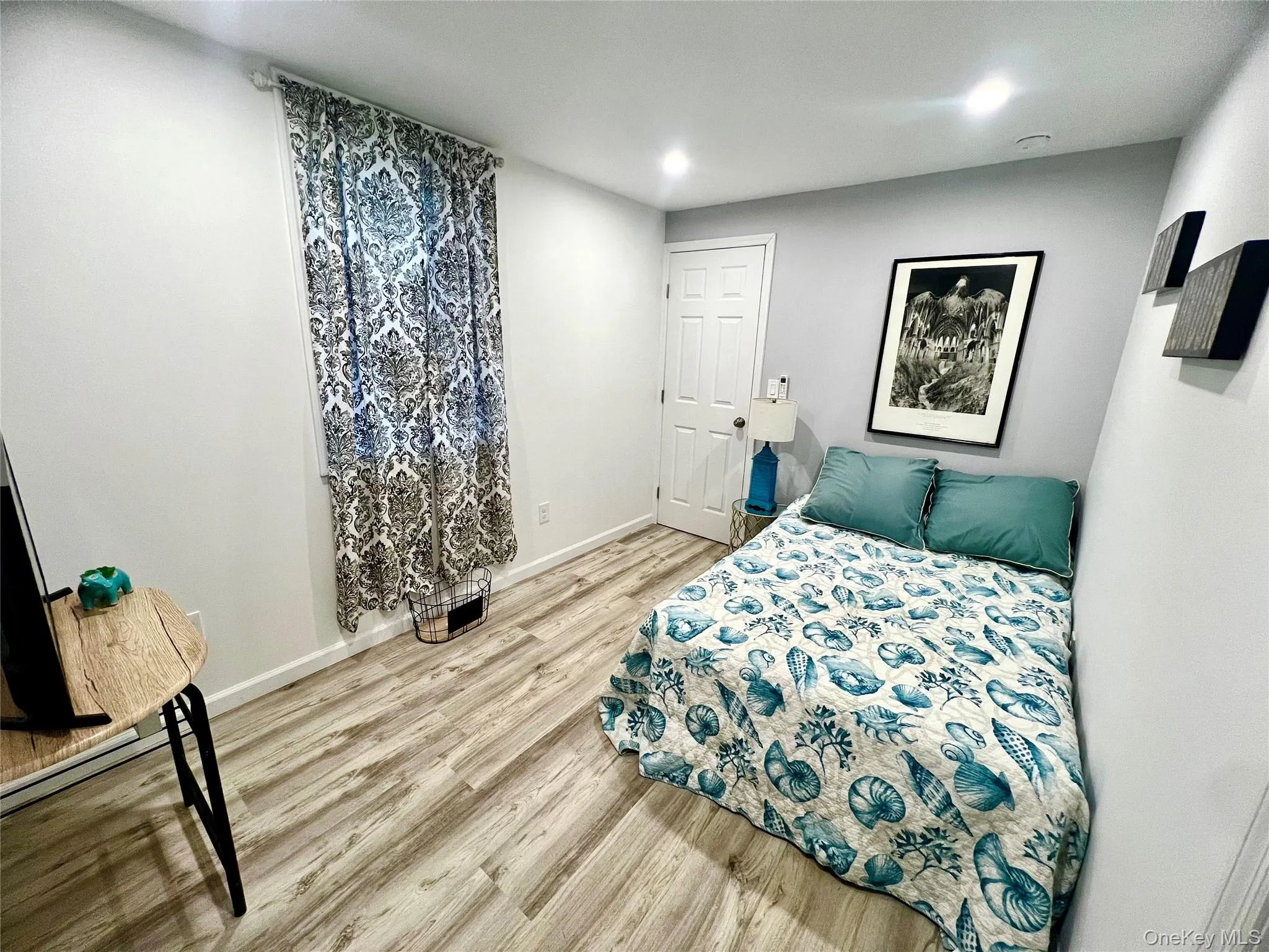 Bedroom with light wood-style floors and recessed lighting Bedroom with light wood-style floors and recessed lighting