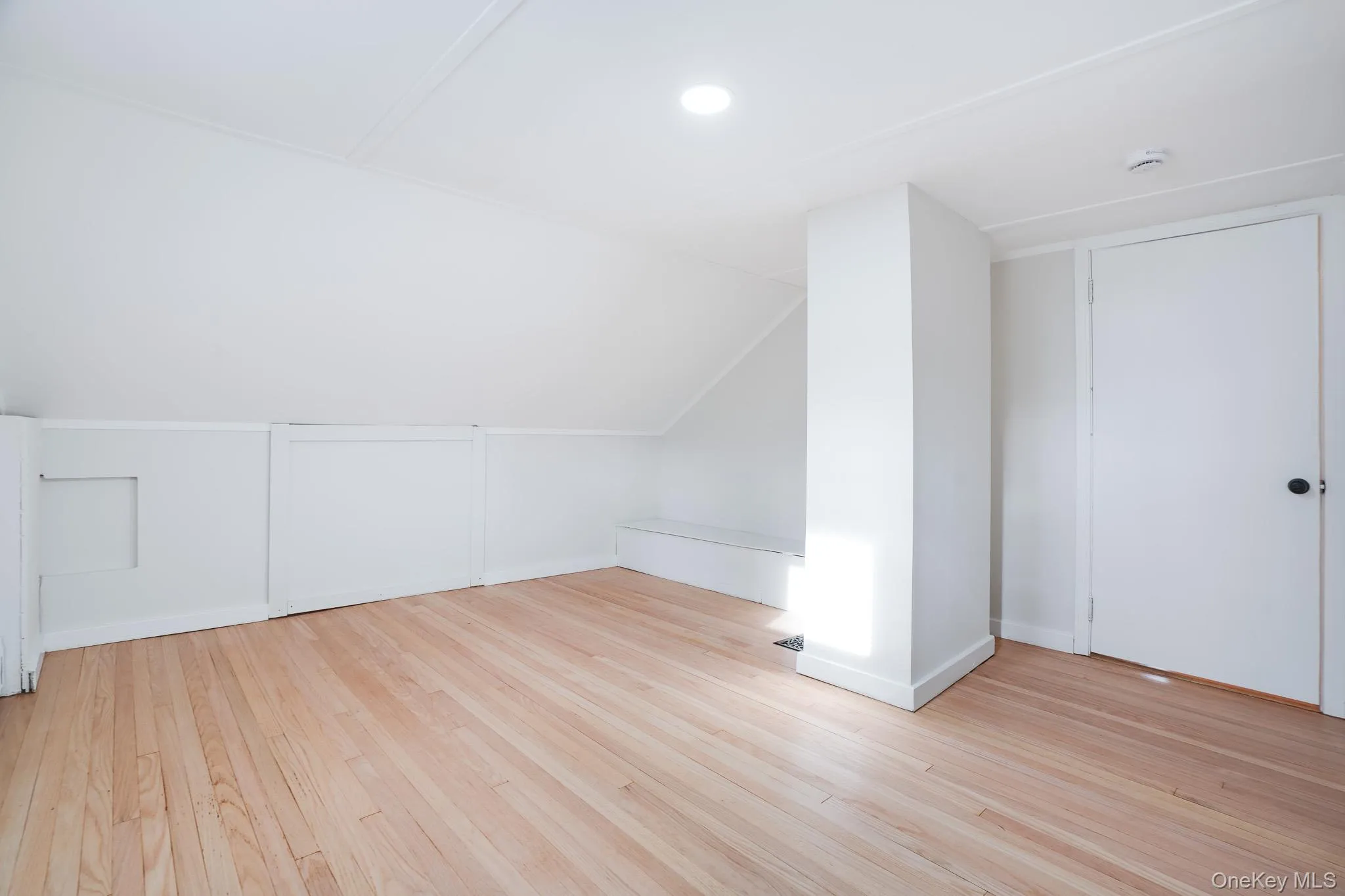 Additional living space with lofted ceiling and light wood-style flooring Additional living space with lofted ceiling and light wood-style flooring