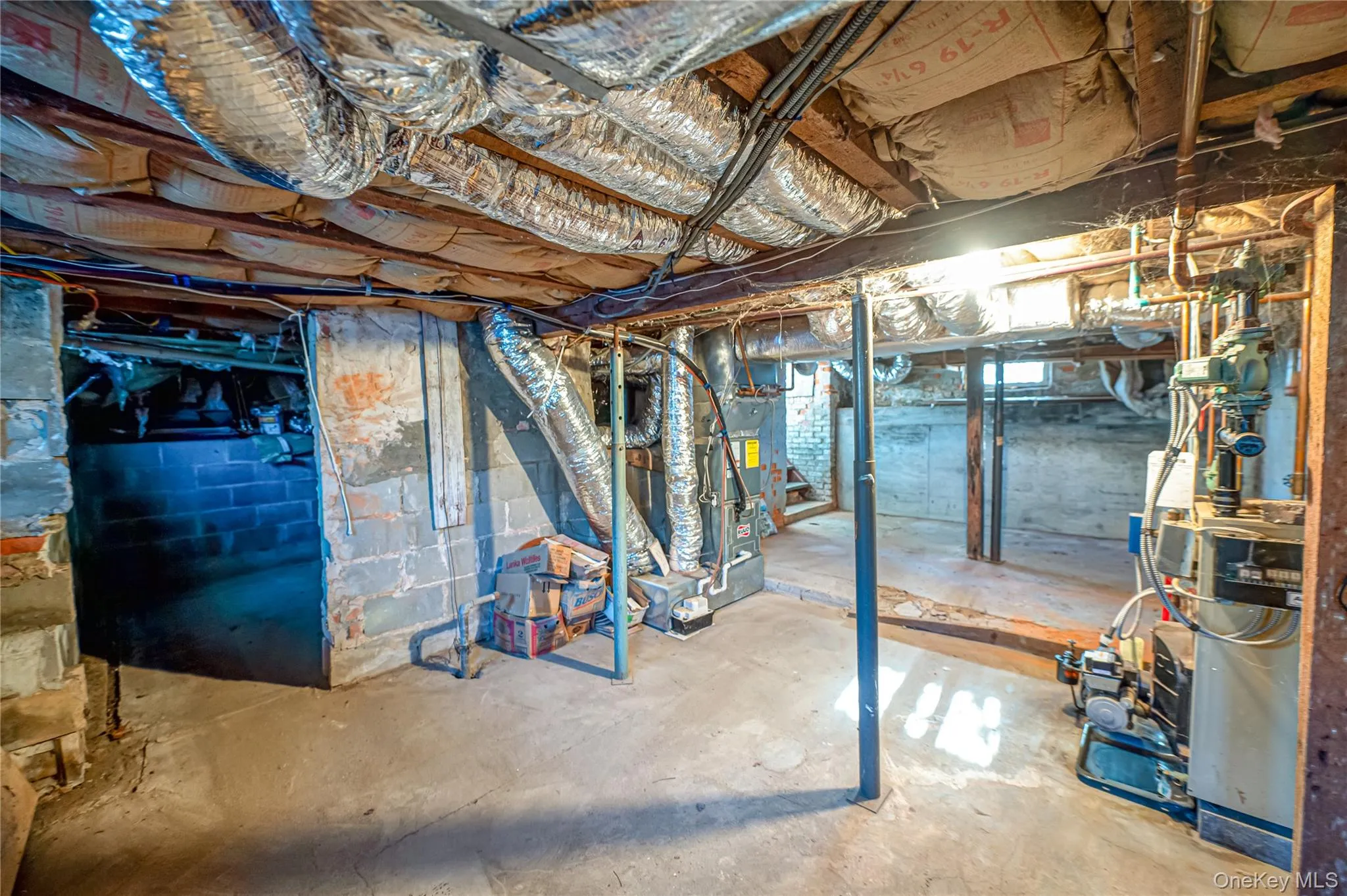 Unfinished basement featuring a heating unit and heating unit Unfinished basement featuring a heating unit and heating unit