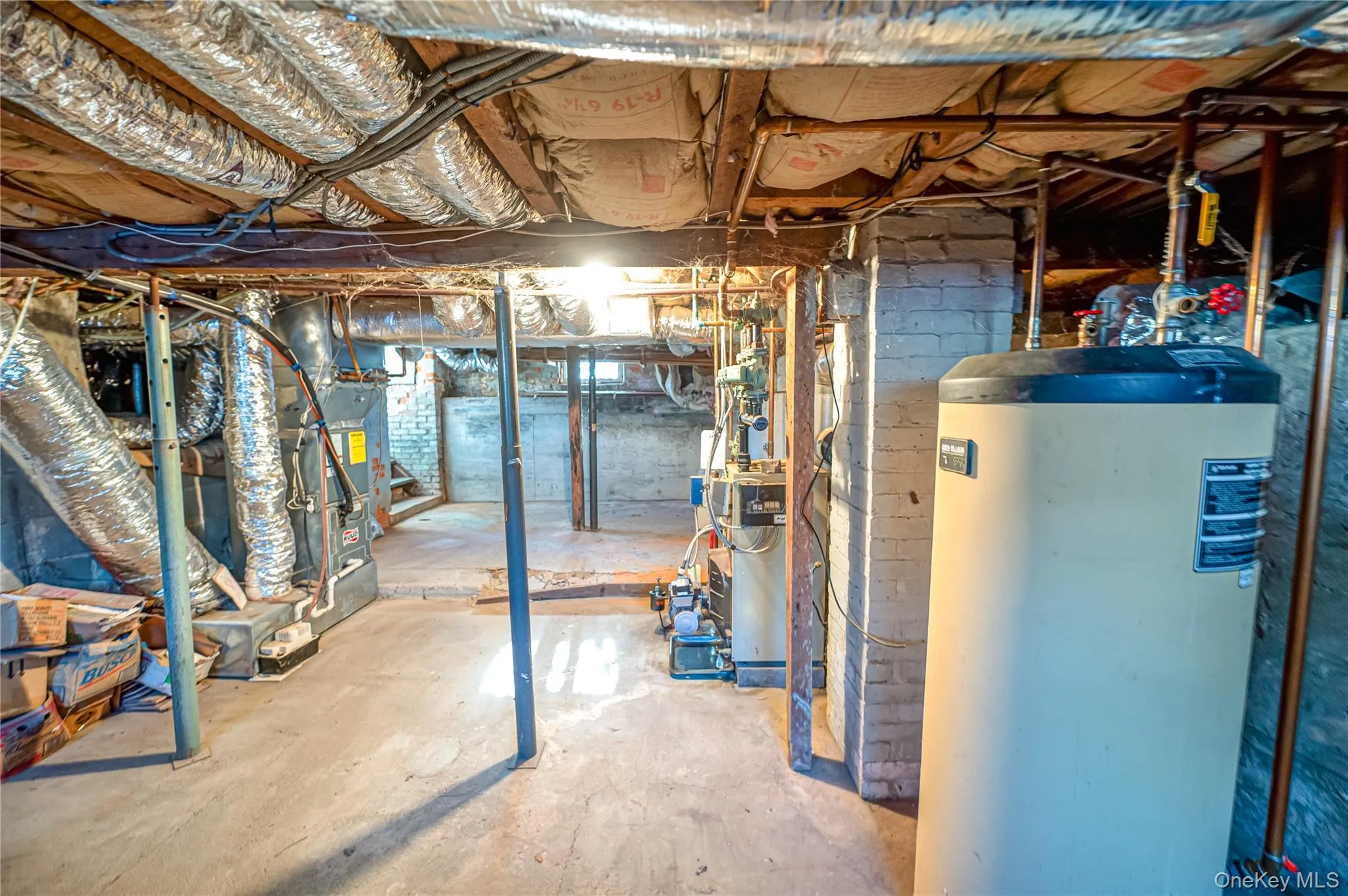 Unfinished basement featuring gas water heater and a heating unit Unfinished basement featuring gas water heater and a heating unit