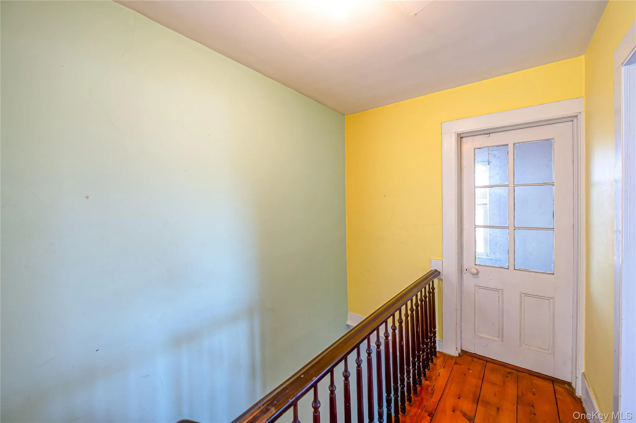 Doorway with hardwood / wood-style floors and baseboards Doorway with hardwood / wood-style floors and baseboards