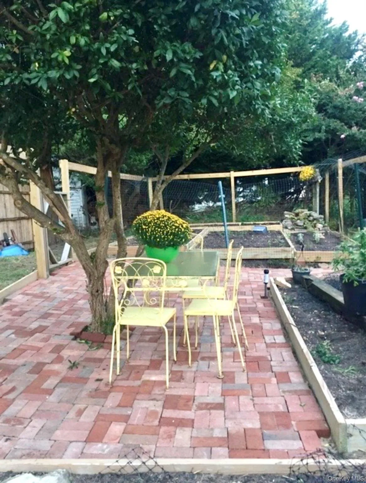 Fenced backyard featuring a garden and a patio area Fenced backyard featuring a garden and a patio area