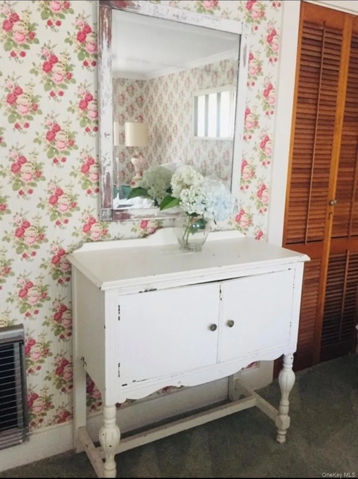 Bathroom featuring wallpapered walls and vanity Bathroom featuring wallpapered walls and vanity