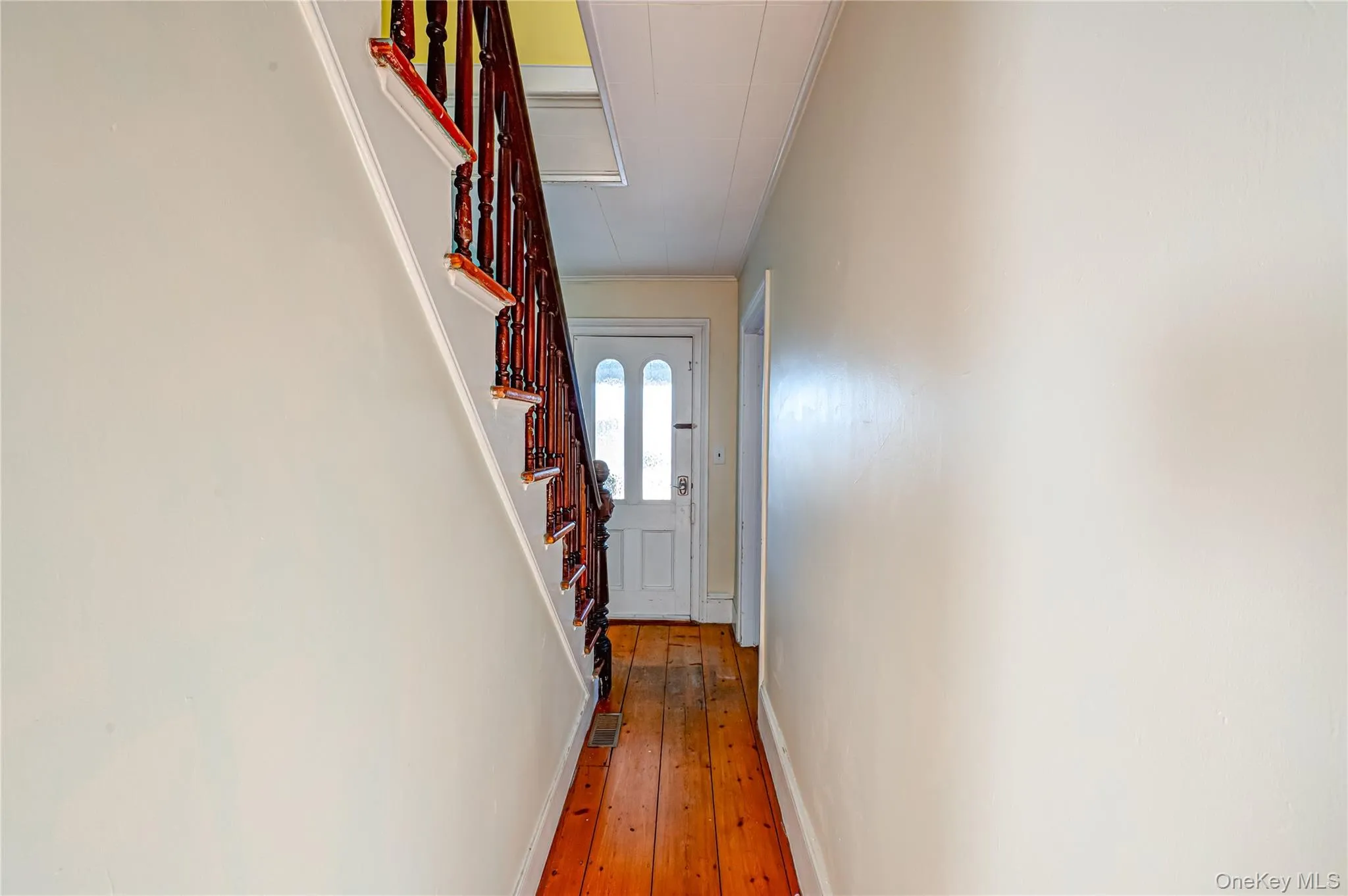 Doorway to outside featuring ornamental molding, stairway, and hardwood / wood-style flooring Doorway to outside featuring ornamental molding, stairway, and hardwood / wood-style flooring