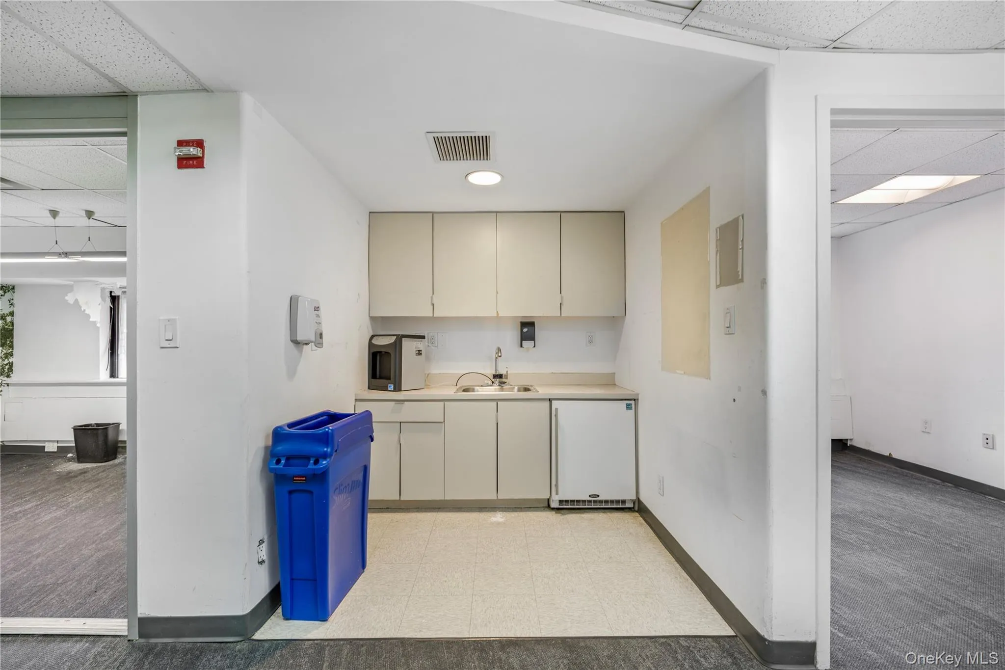 Kitchen with a paneled ceiling, light countertops, and dishwasher Kitchen with a paneled ceiling, light countertops, and dishwasher