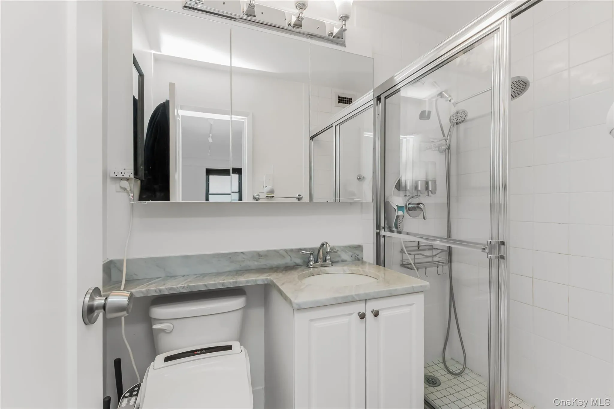 Bathroom featuring vanity and a shower stall Bathroom featuring vanity and a shower stall