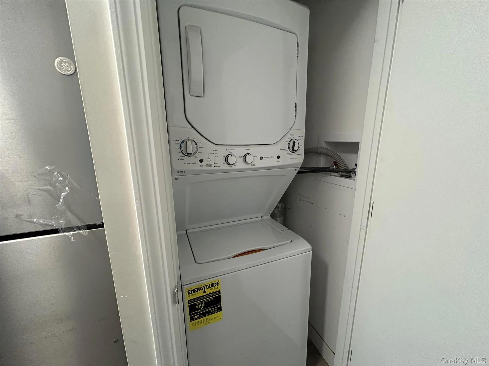 Laundry area with stacked washing machine and dryer Laundry area with stacked washing machine and dryer