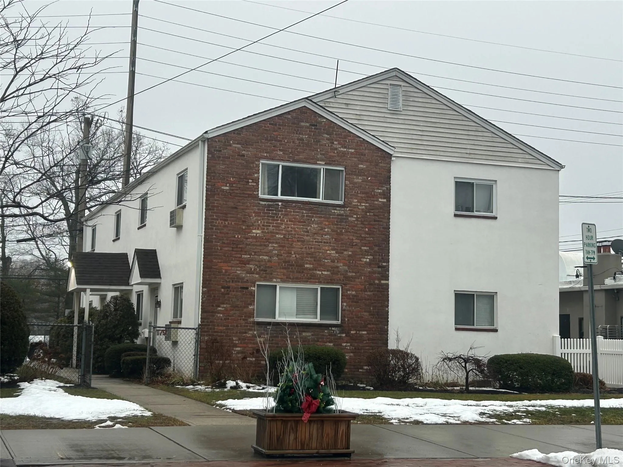 View of snow covered exterior featuring brick siding and stucco siding View of snow covered exterior featuring brick siding and stucco siding