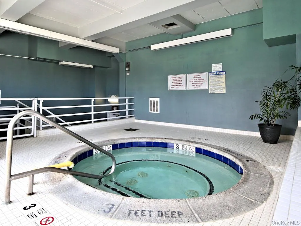 View of swimming pool featuring a hot tub View of swimming pool featuring a hot tub