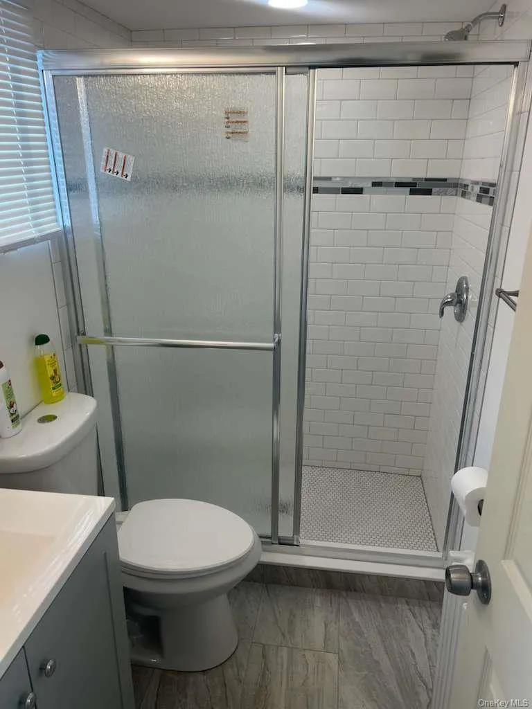 Full bathroom with a stall shower and vanity Full bathroom with a stall shower and vanity