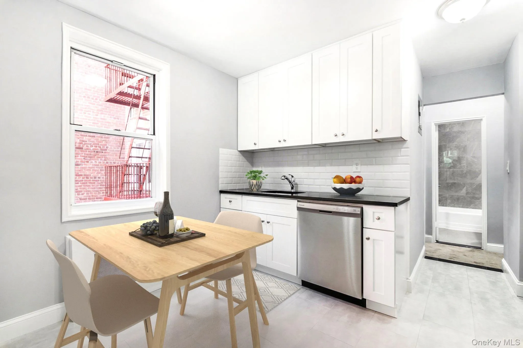 Kitchen featuring stainless steel dishwasher, white cabinetry, and tasteful backsplash Kitchen featuring stainless steel dishwasher, white cabinetry, and tasteful backsplash