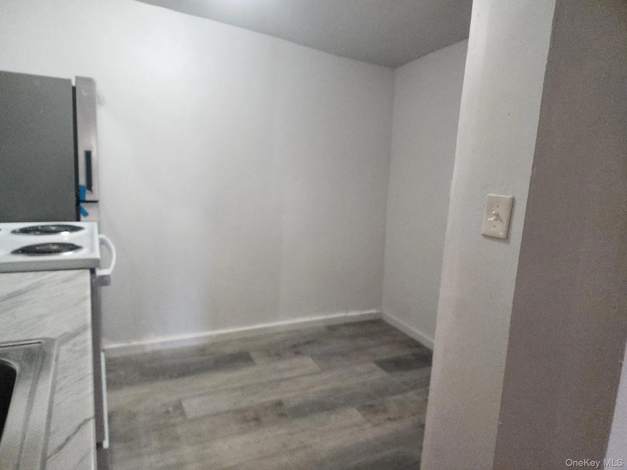 Laundry area with light wood-style flooring and baseboards Laundry area with light wood-style flooring and baseboards