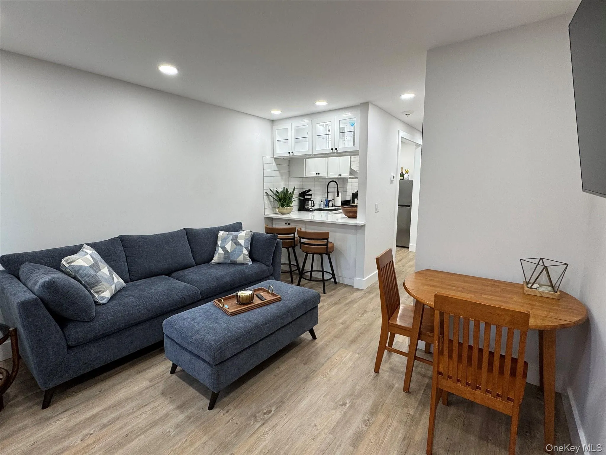 Living room featuring recessed lighting and light wood-style floors Living room featuring recessed lighting and light wood-style floors