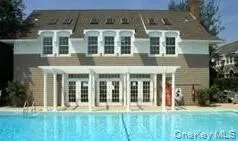 Back of property featuring a community pool Back of property featuring a community pool