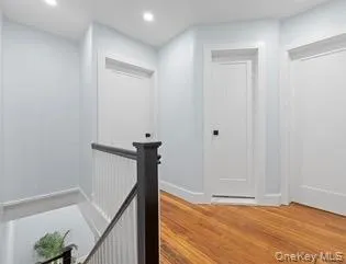 Corridor featuring an upstairs landing, recessed lighting, and light wood-style floors Corridor featuring an upstairs landing, recessed lighting, and light wood-style floors
