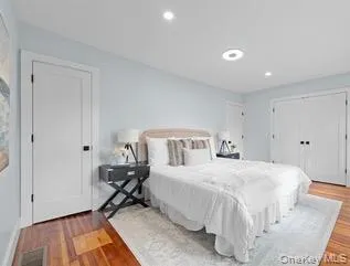 Bedroom featuring wood finished floors and recessed lighting Bedroom featuring wood finished floors and recessed lighting