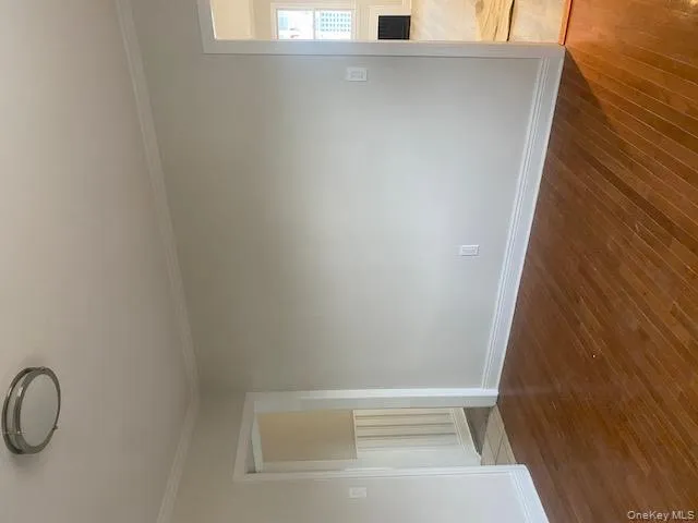 Unfurnished room with hardwood / wood-style floors and crown molding Unfurnished room with hardwood / wood-style floors and crown molding