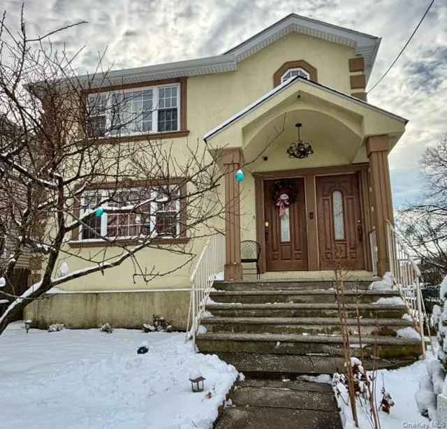 Snow covered property entrance featuring stucco siding Snow covered property entrance featuring stucco siding