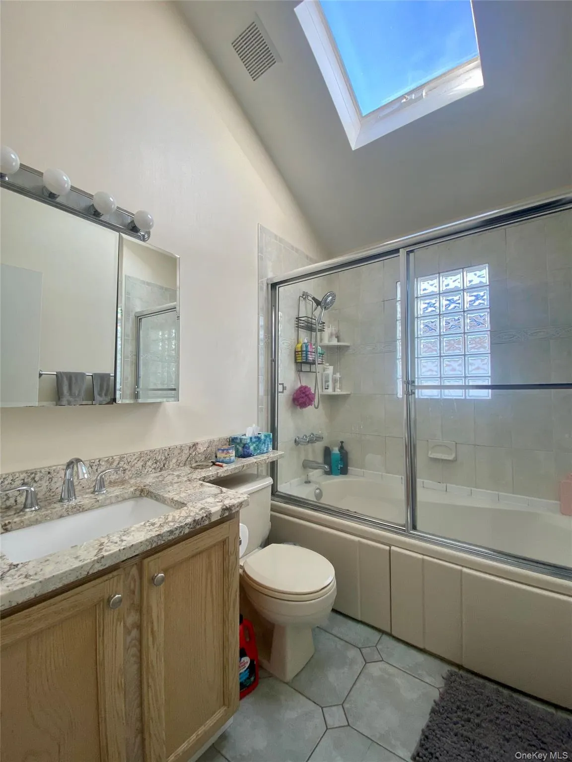 Full bathroom with a skylight Full bathroom with a skylight