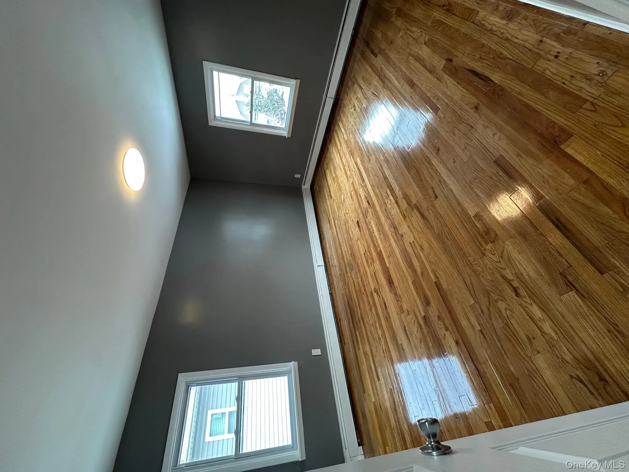 Unfurnished room with baseboard heating and light wood-type flooring Unfurnished room with baseboard heating and light wood-type flooring