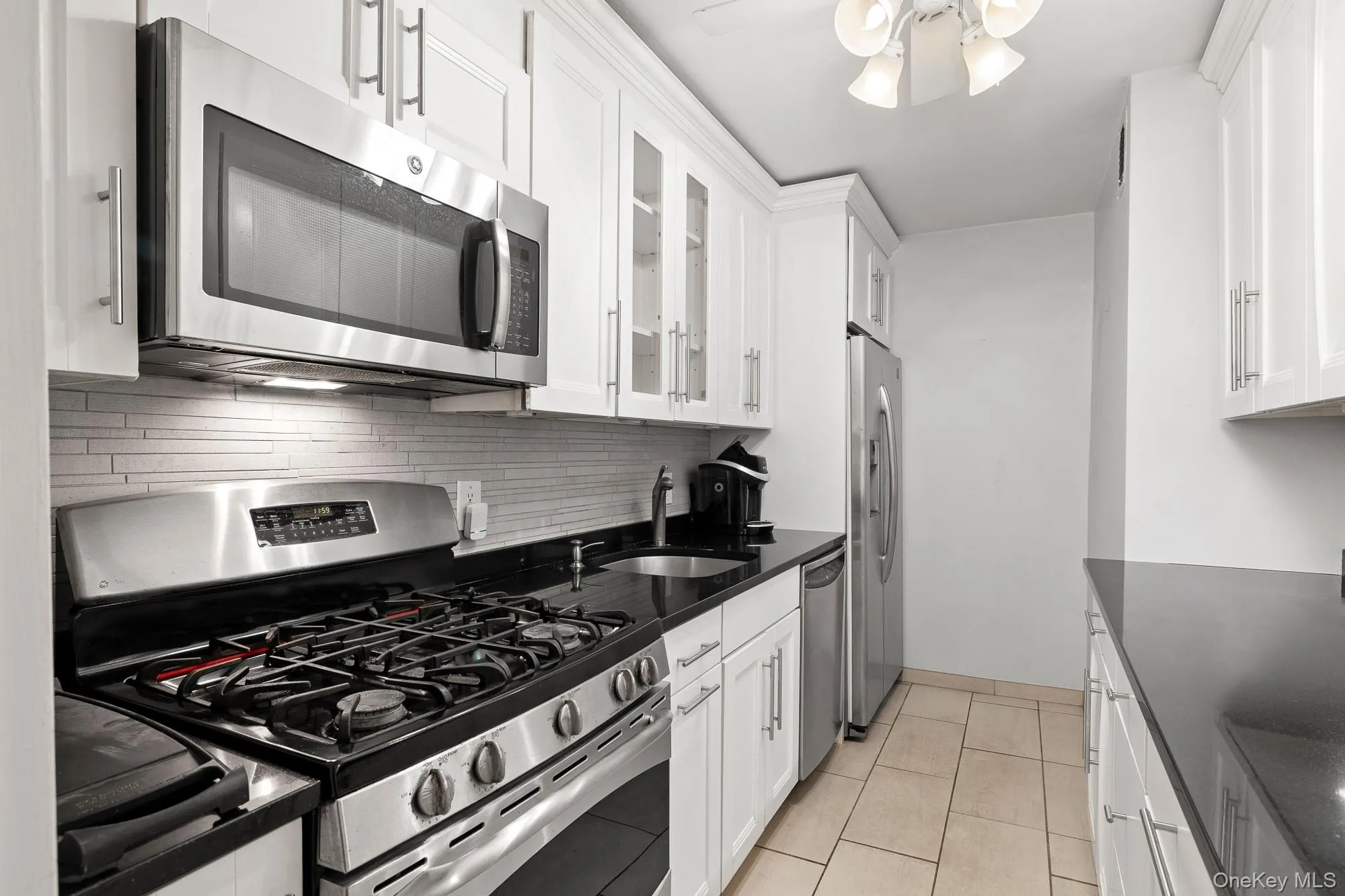 Galley Kitchen with Stainless Steel appliances, granite counters and decorative backsplash Galley Kitchen with Stainless Steel appliances, granite counters and decorative backsplash