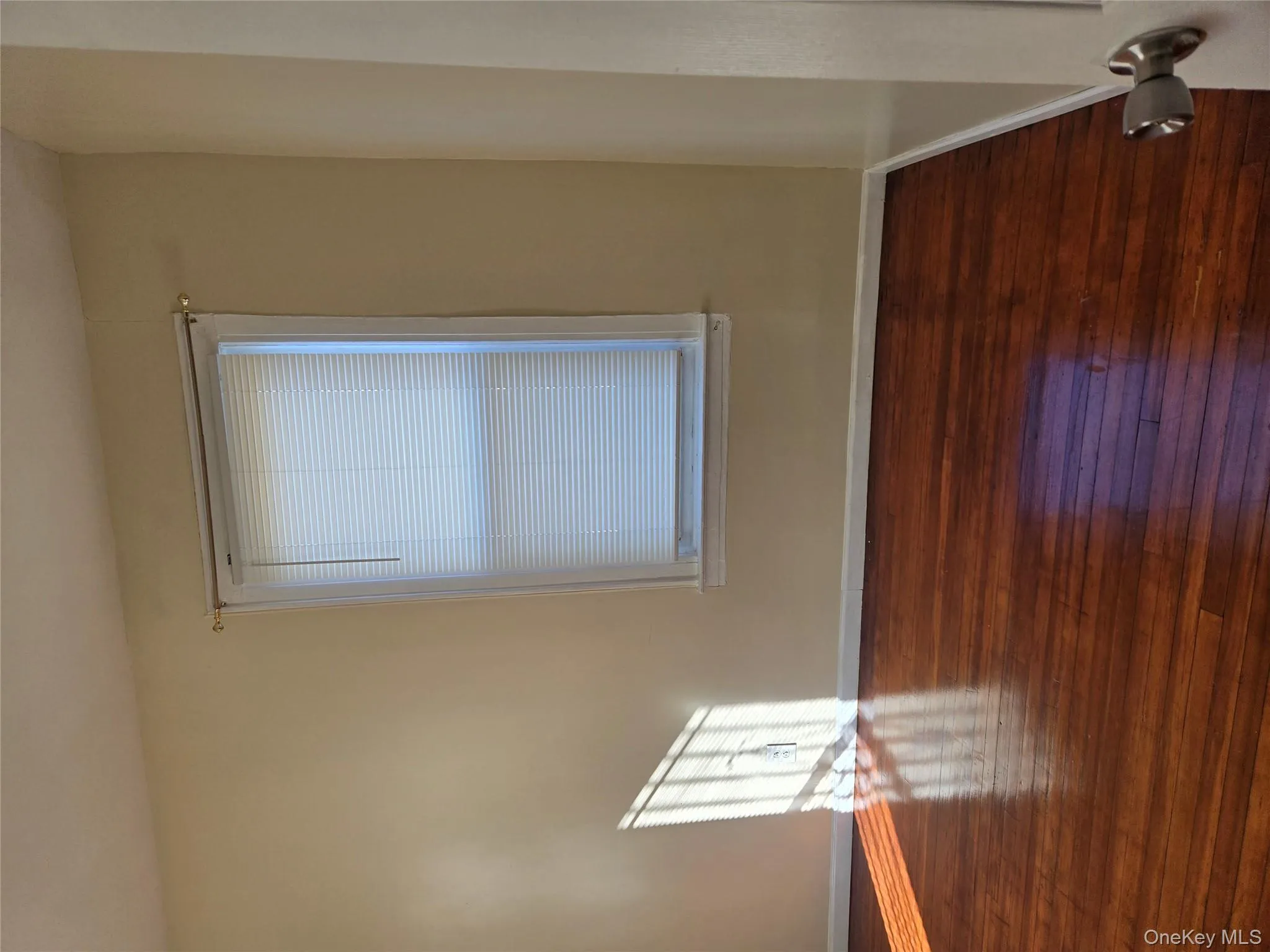Spare room featuring dark wood-style floors and baseboards Spare room featuring dark wood-style floors and baseboards