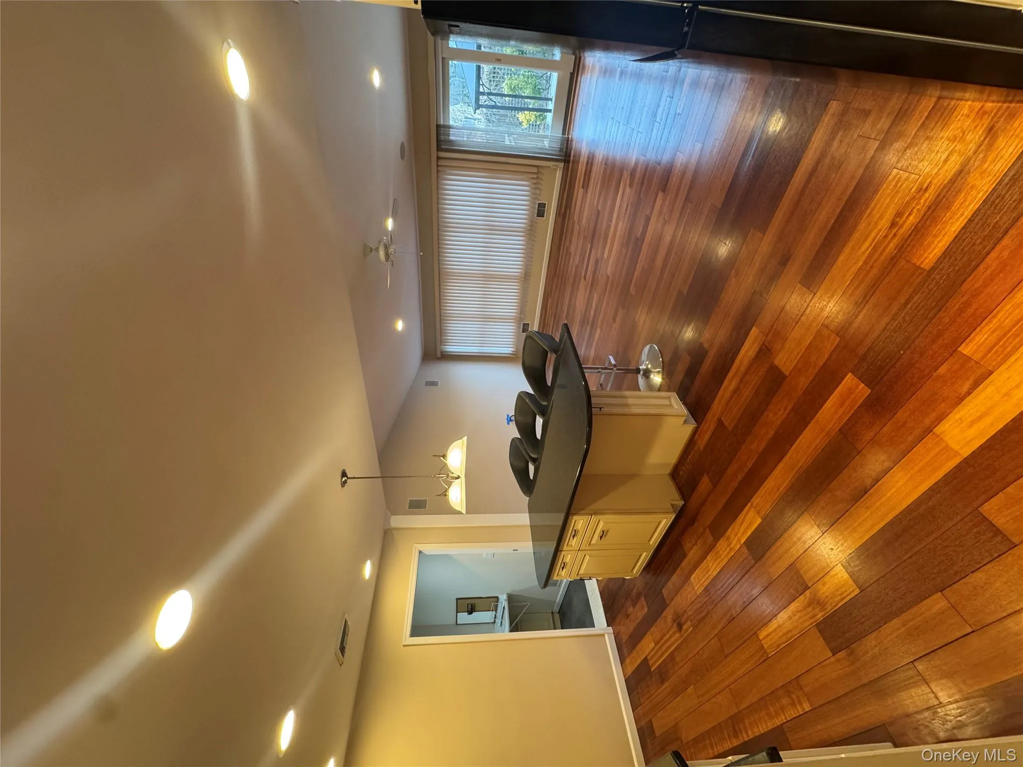 Kitchen featuring open floor plan, a breakfast bar area, recessed lighting, hanging light fixtures, and fridge Kitchen featuring open floor plan, a breakfast bar area, recessed lighting, hanging light fixtures, and fridge