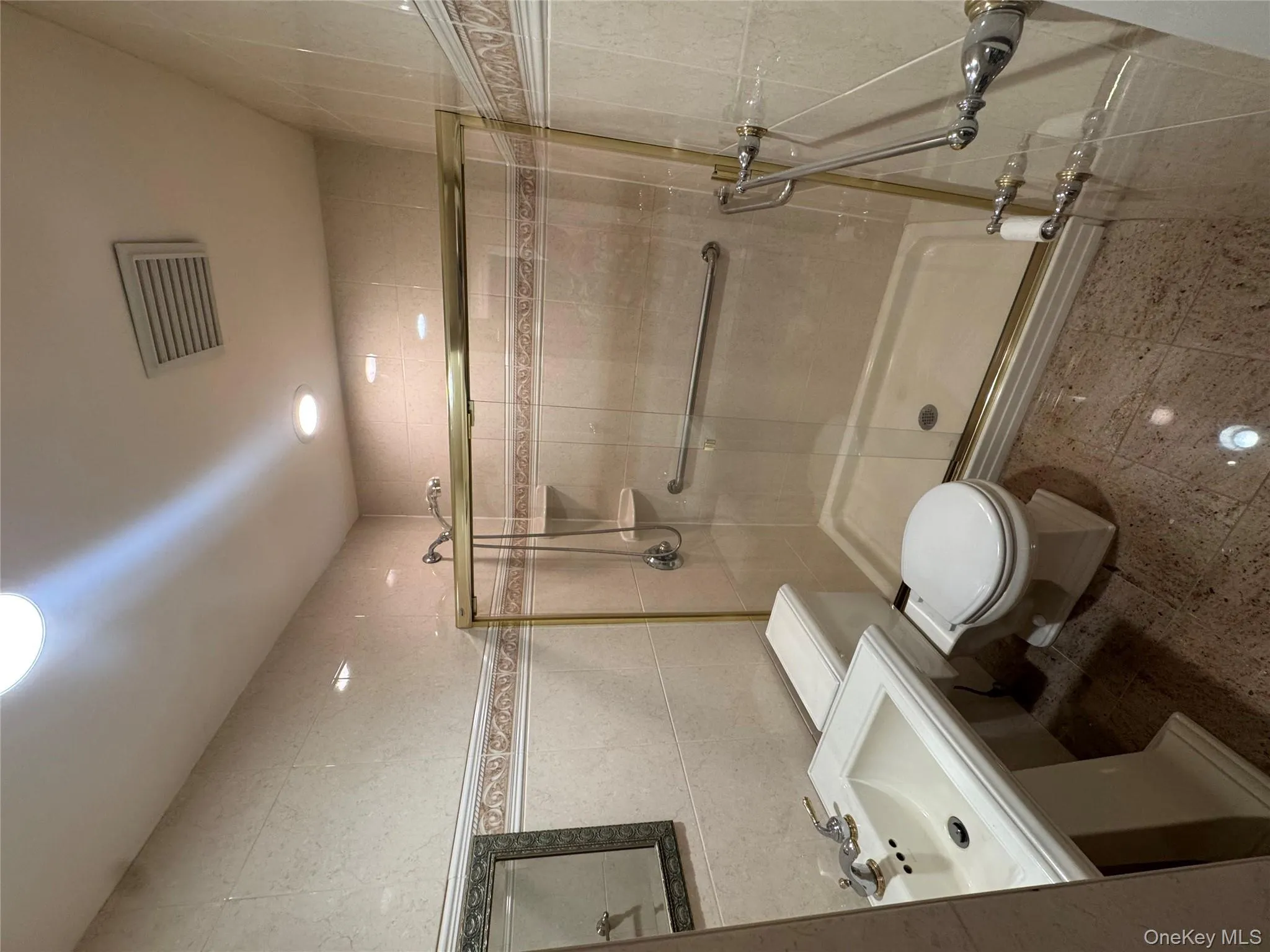 Full bathroom with tile walls, a stall shower, and recessed lighting Full bathroom with tile walls, a stall shower, and recessed lighting