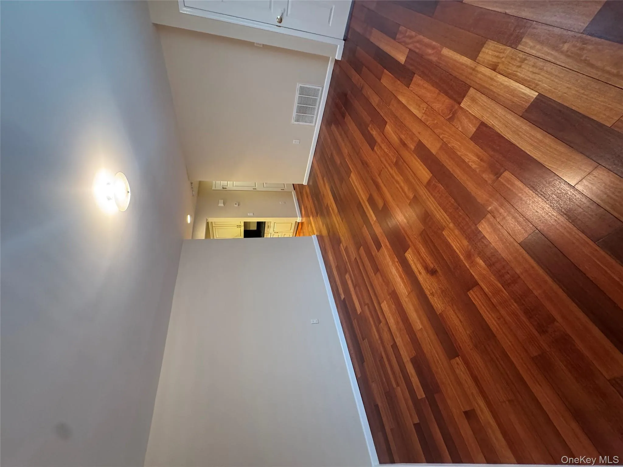 Unfurnished room with dark wood-style floors and baseboards Unfurnished room with dark wood-style floors and baseboards