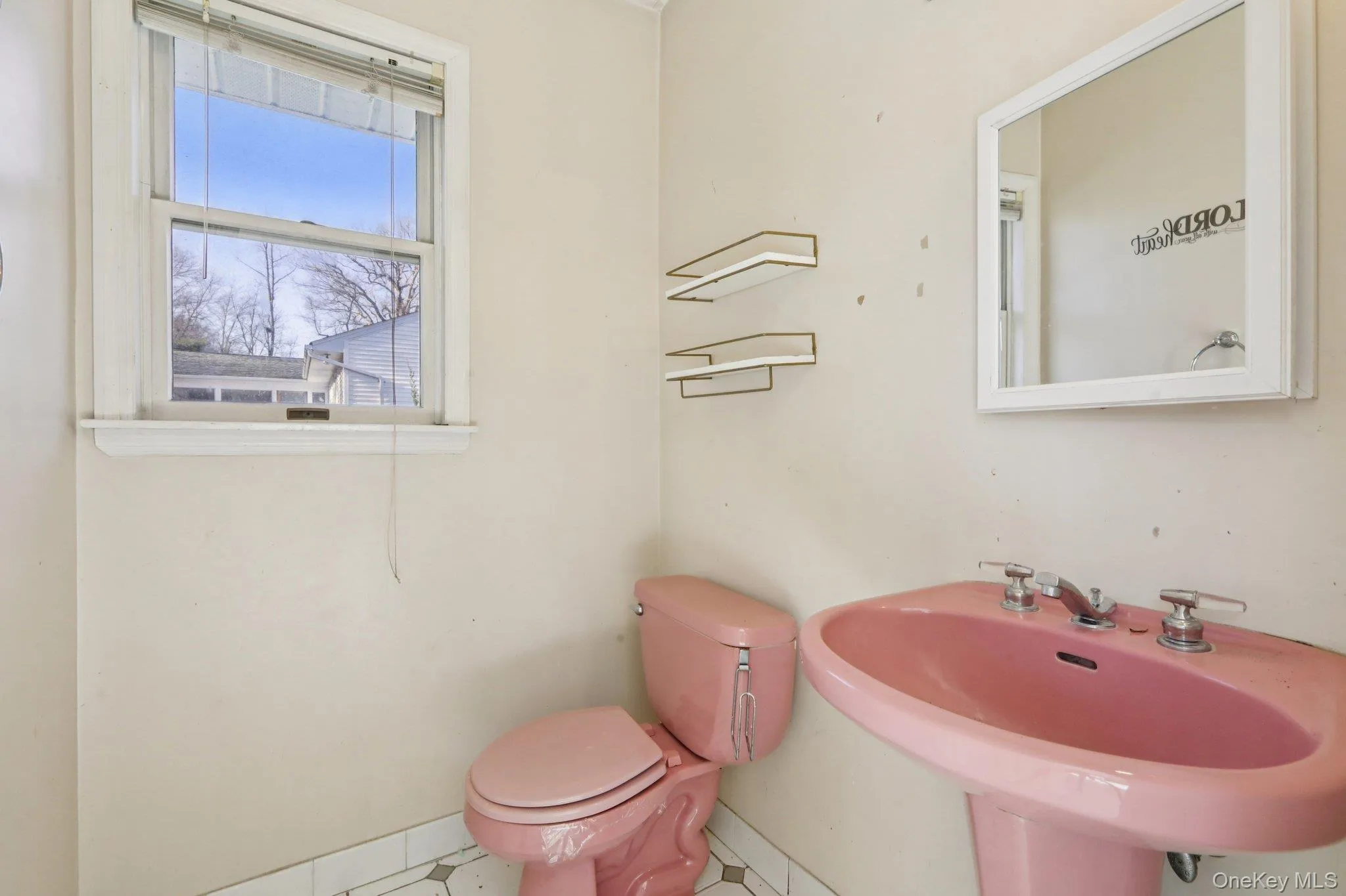 Half bathroom featuring toilet and tile patterned flooring Half bathroom featuring toilet and tile patterned flooring