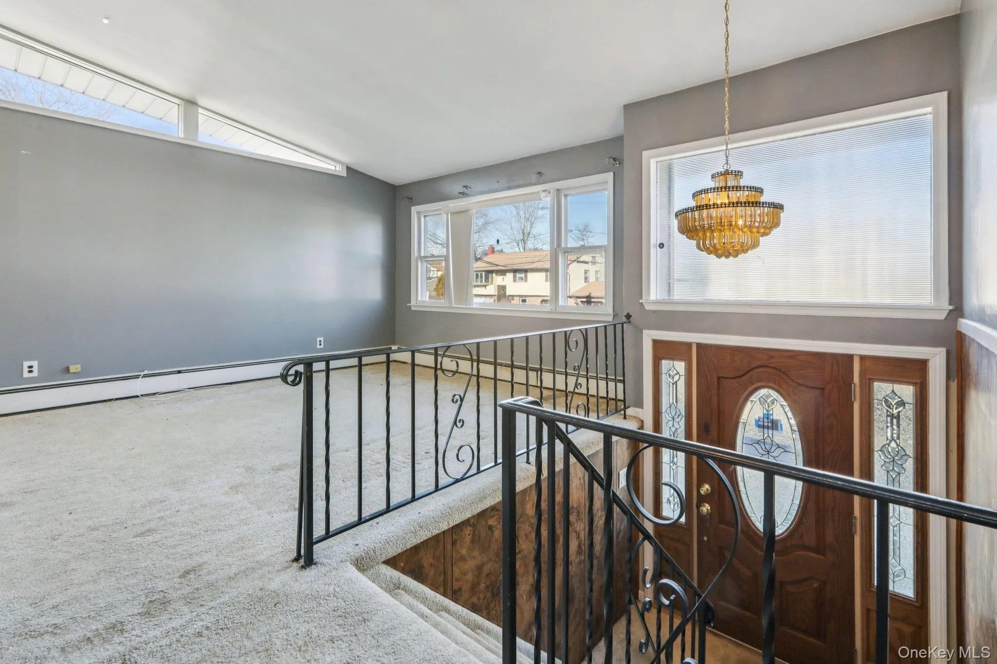 Staircase with carpet floors and a chandelier Staircase with carpet floors and a chandelier