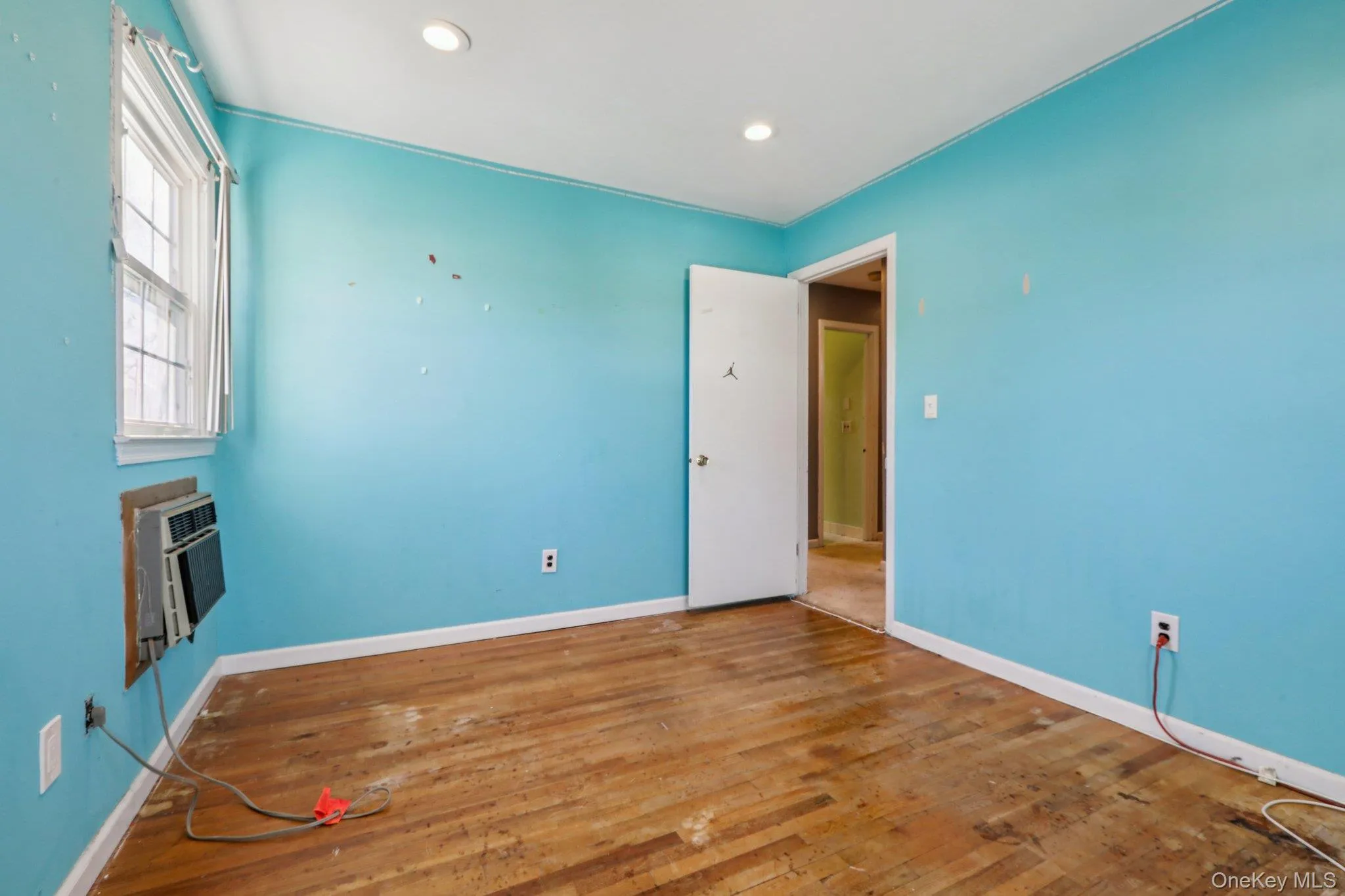 Unfurnished room with hardwood / wood-style floors, recessed lighting, and heating unit Unfurnished room with hardwood / wood-style floors, recessed lighting, and heating unit
