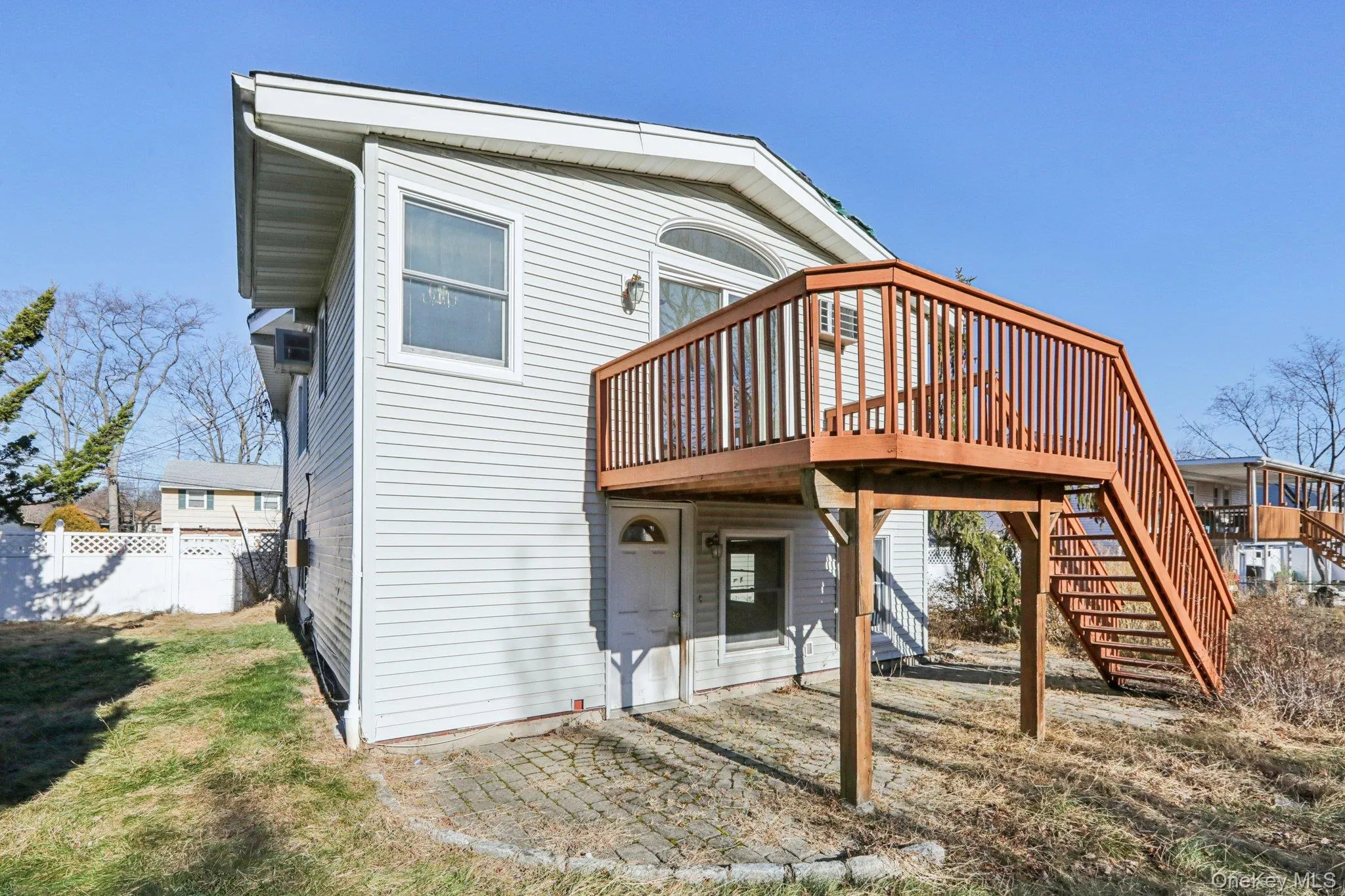 Back of house featuring a wooden deck, stairs, and a patio Back of house featuring a wooden deck, stairs, and a patio