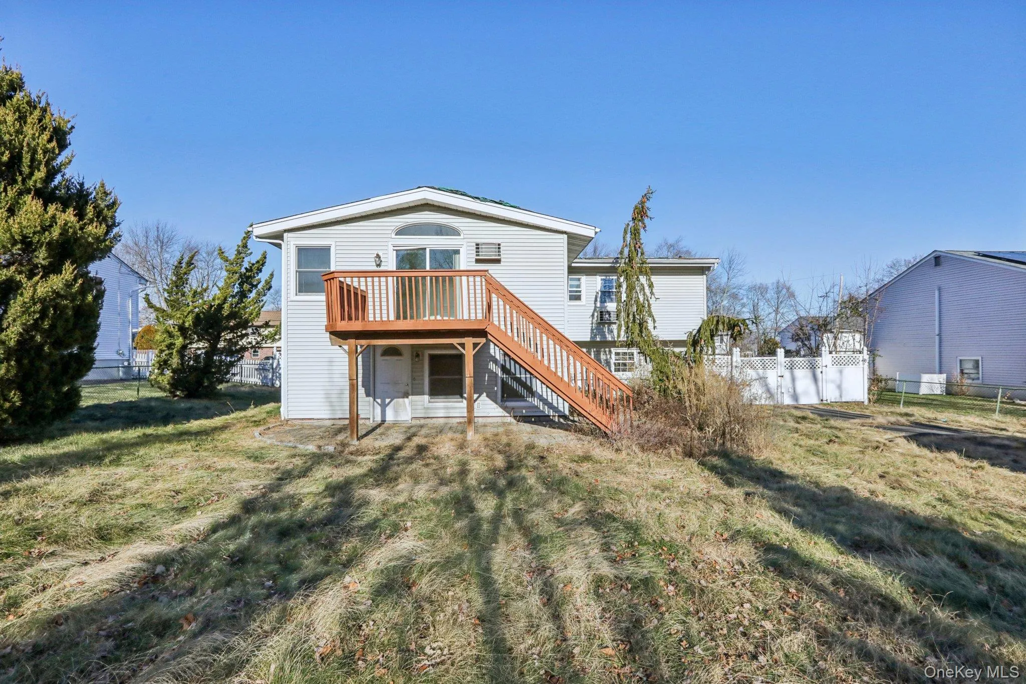 Rear view of property with stairway and a deck Rear view of property with stairway and a deck