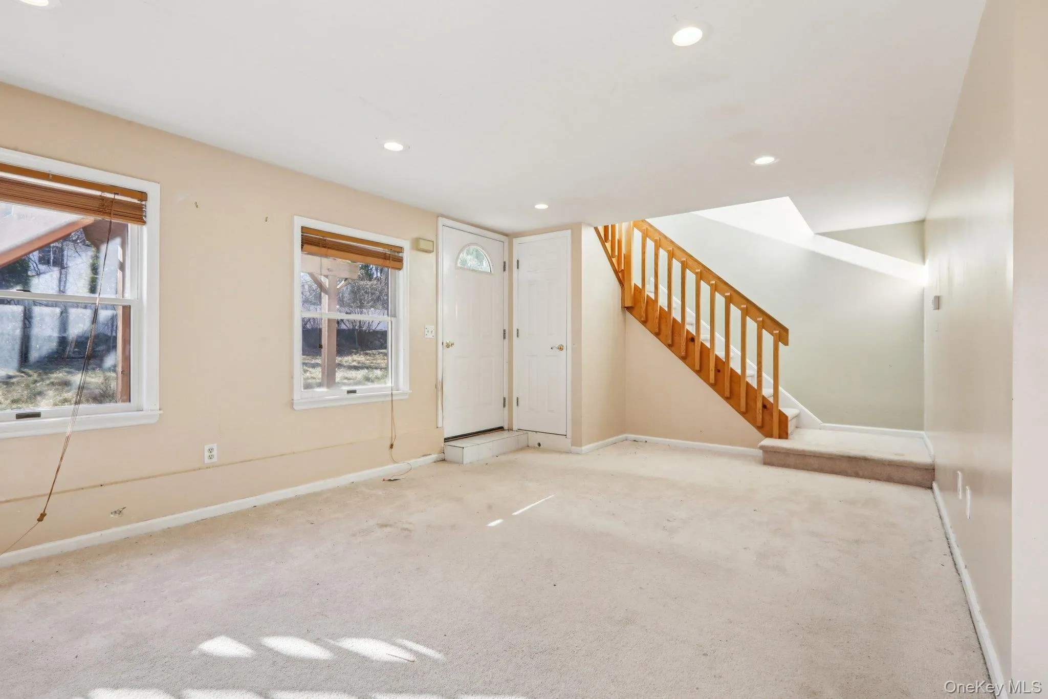 Unfurnished living room featuring carpet flooring, stairway, and recessed lighting Unfurnished living room featuring carpet flooring, stairway, and recessed lighting