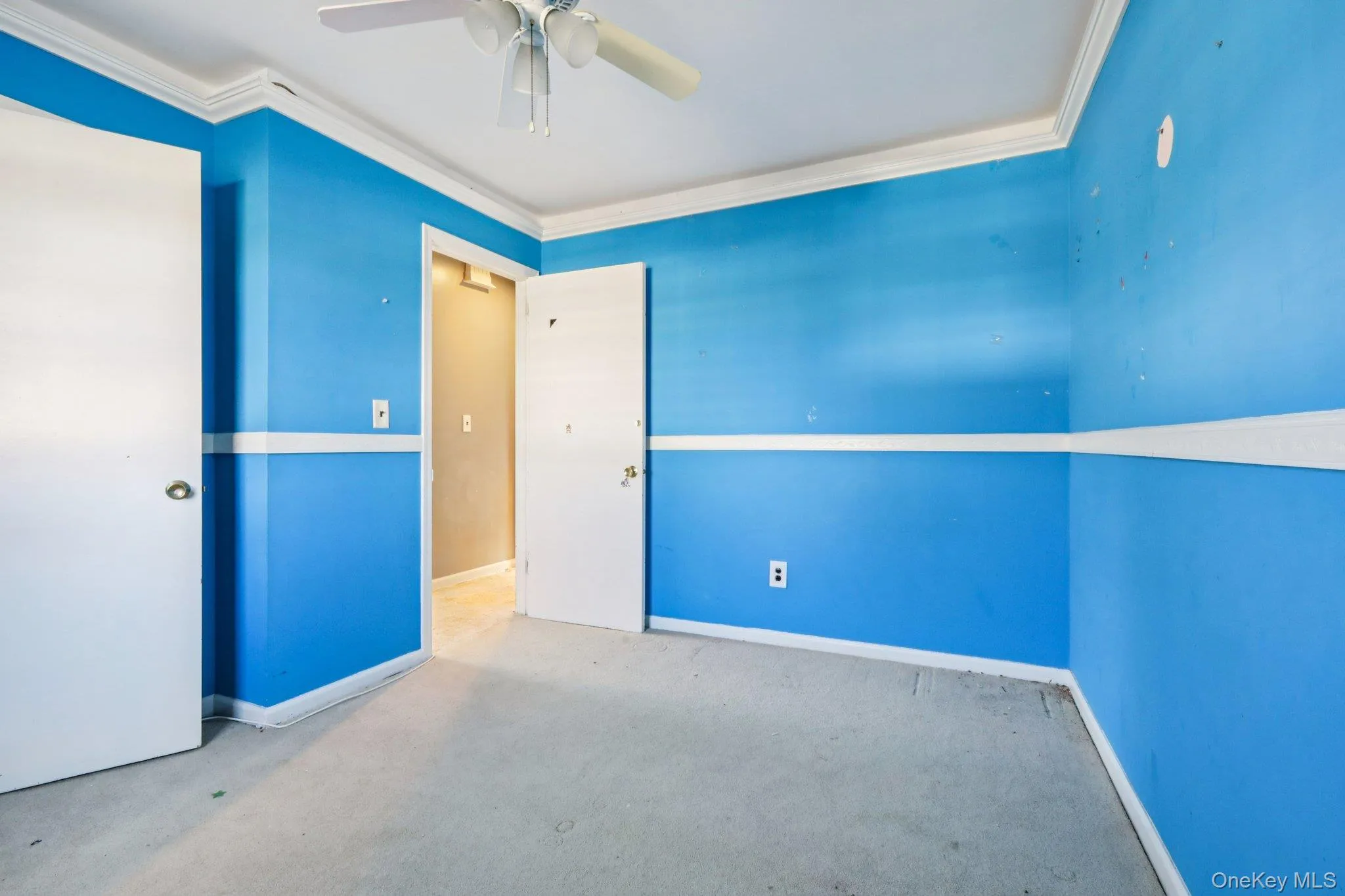 Unfurnished bedroom featuring ornamental molding, carpet flooring, and ceiling fan Unfurnished bedroom featuring ornamental molding, carpet flooring, and ceiling fan