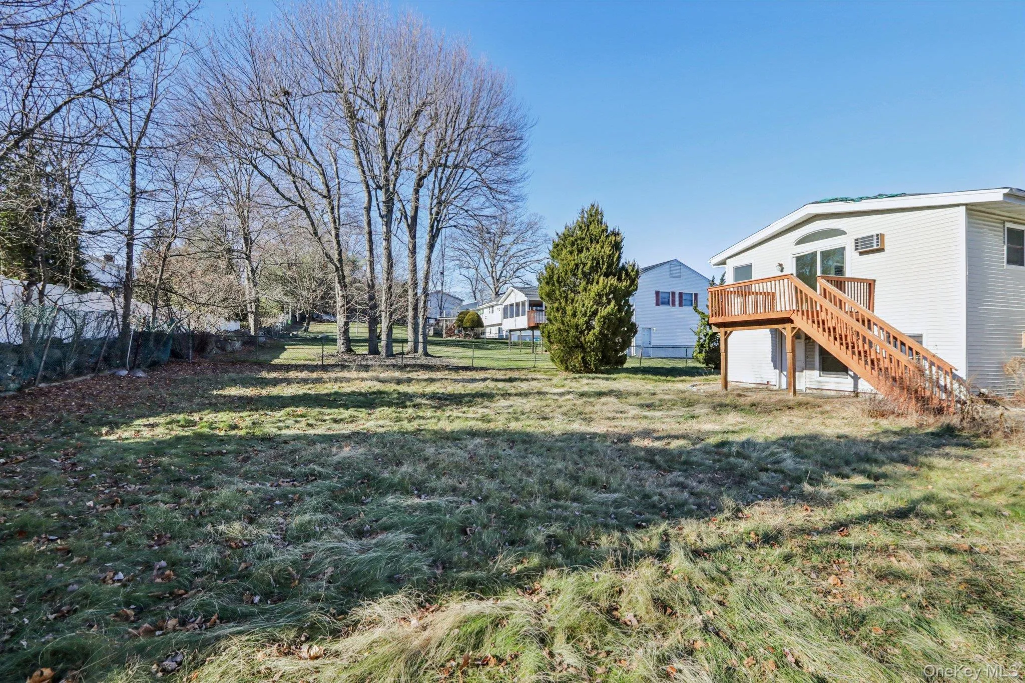 View of yard featuring stairs and a wooden deck View of yard featuring stairs and a wooden deck