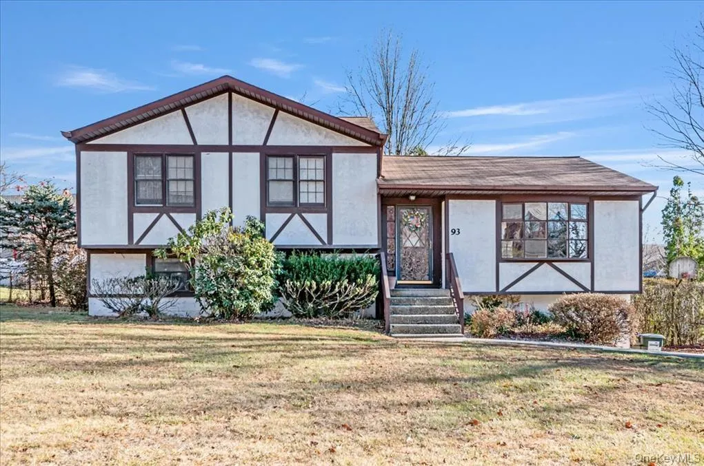 View of front of house featuring a front yard and stucco siding View of front of house featuring a front yard and stucco siding